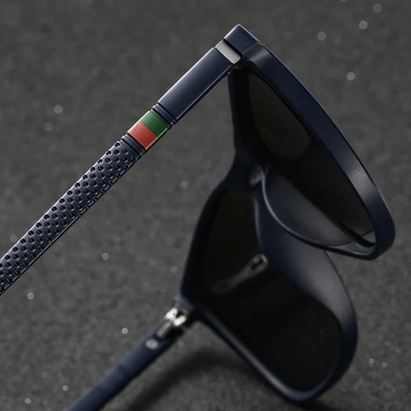 Black sunglasses with a textured blue strap on a dark background