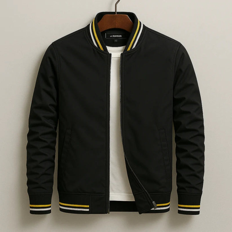 Black bomber jacket with yellow accents on a hanger against a neutral background