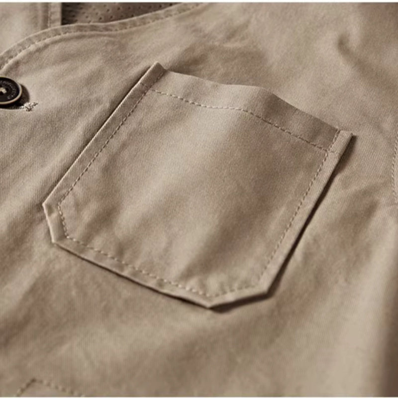 Close-up detail of chest pocket on men’s khaki multi-pocket vest.