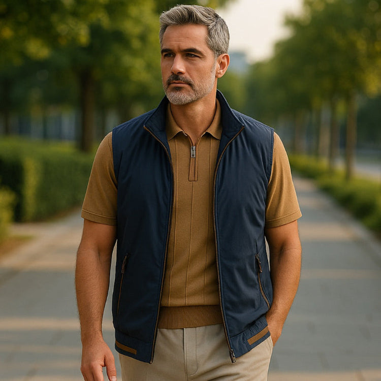 Polumi Fall-Winter 2026 men’s collection — model wearing navy vest and beige pants in outdoor campaign showcasing elegant casualwear.