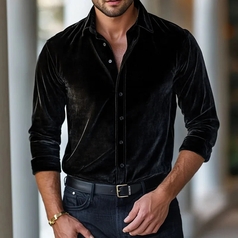 Man wearing a black velvet shirt with a blurred background