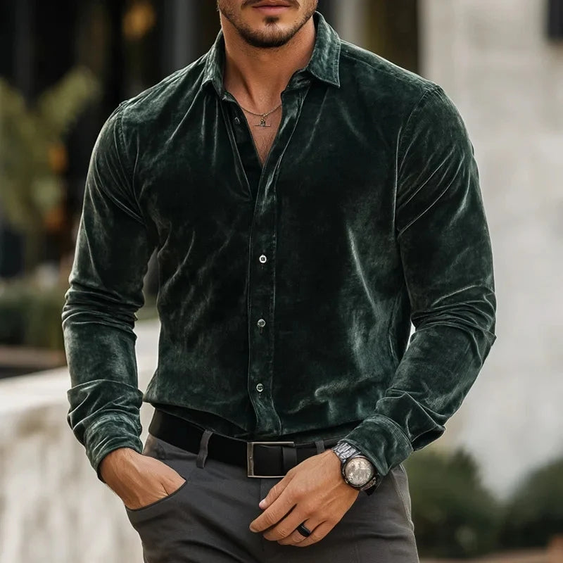 Man wearing a green velvet shirt with a blurred background
