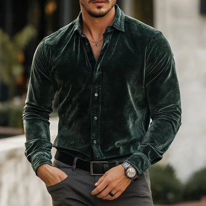 Man wearing a green velvet shirt with a blurred background