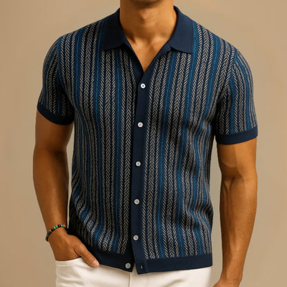 Man wearing a blue patterned shirt against a beige background