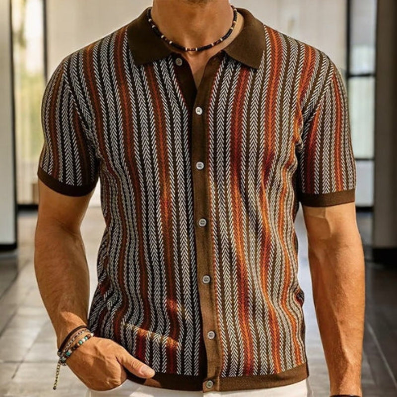 Man wearing a patterned shirt with a blurred background
