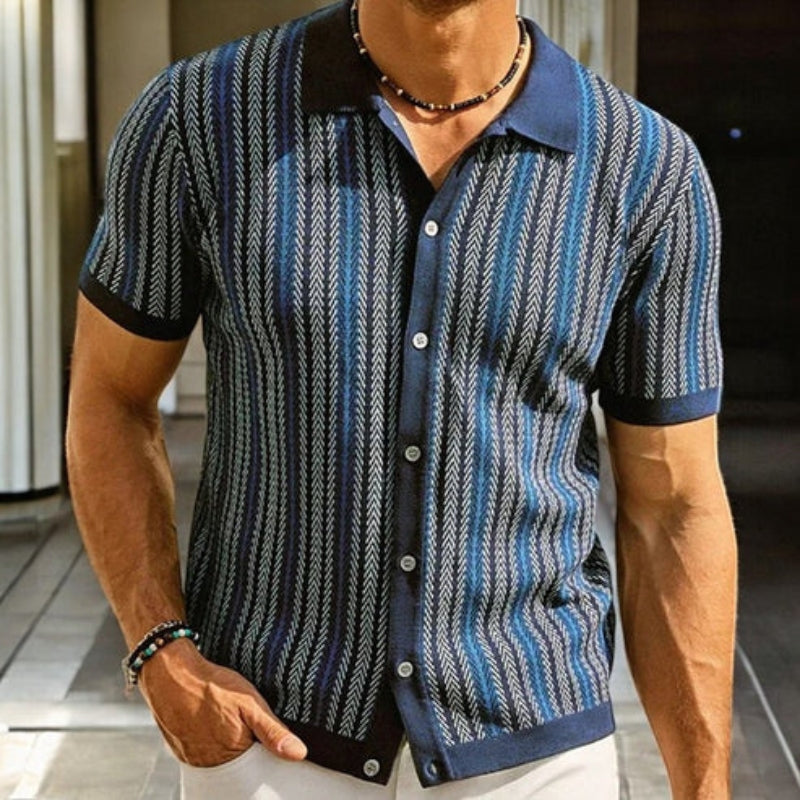 Man wearing a patterned short-sleeve shirt with a blurred background