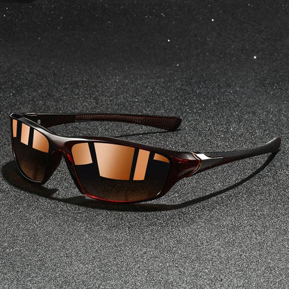 Sunglasses with brown reflective lenses on a dark textured surface
