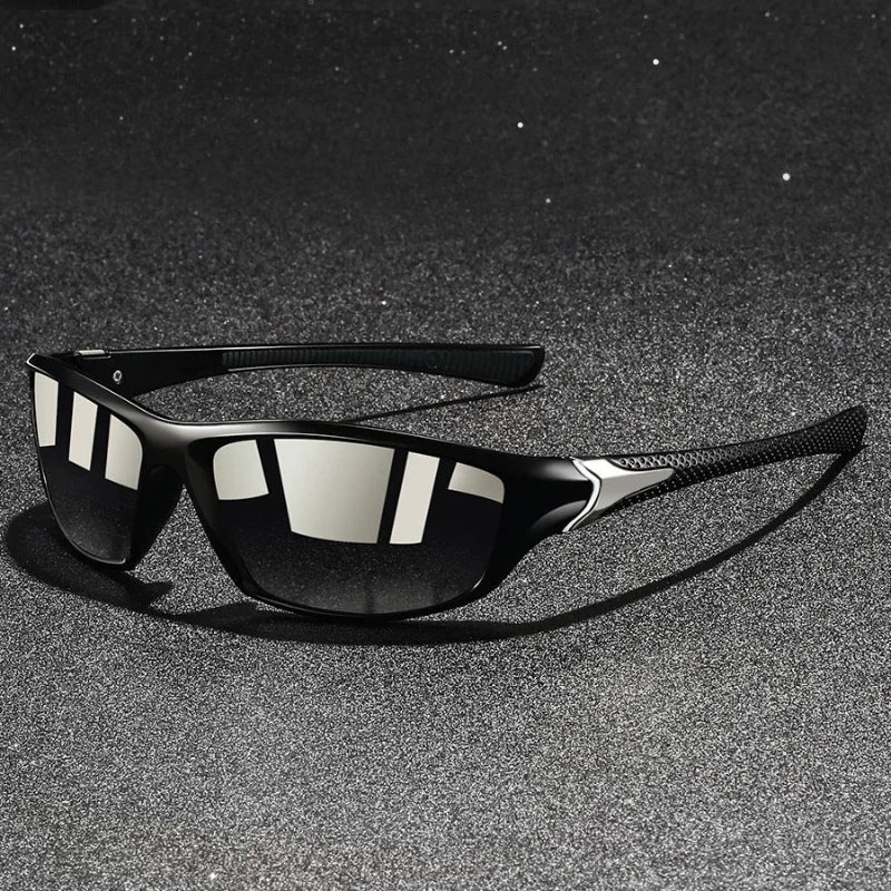 Black sunglasses with reflective lenses on a dark textured surface