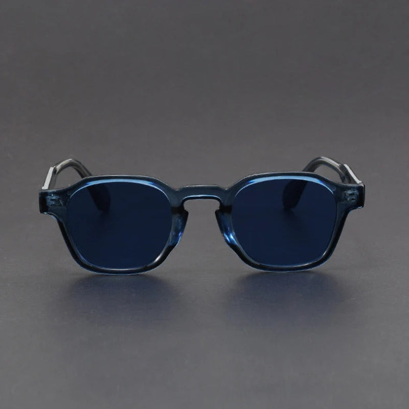 Blue sunglasses with dark lenses on a gray background