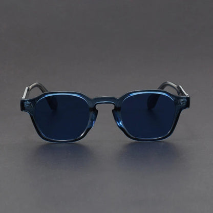 Blue sunglasses with dark lenses on a gray background