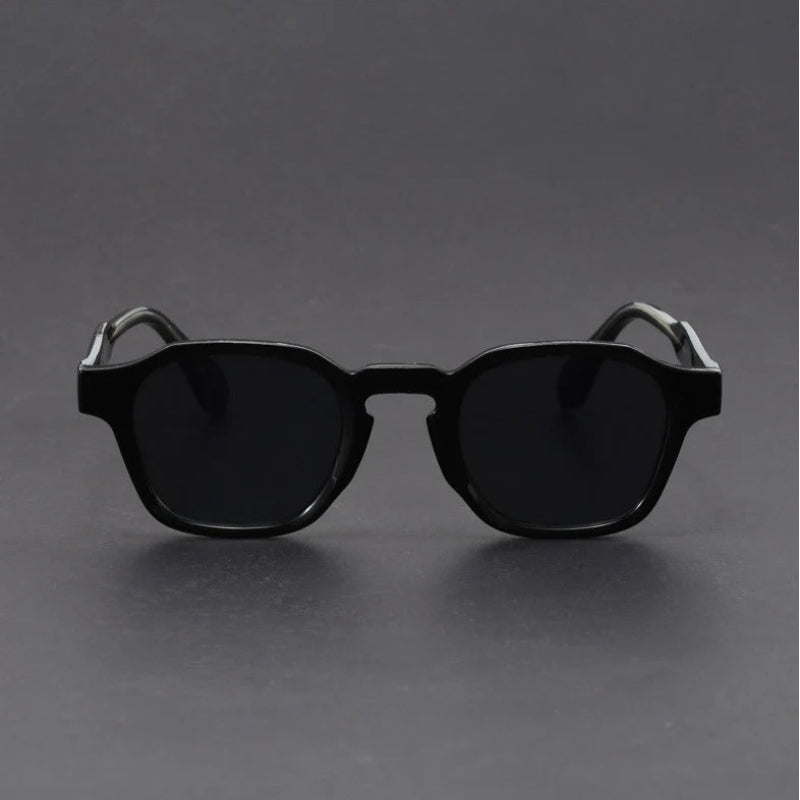 Black sunglasses on a gray background