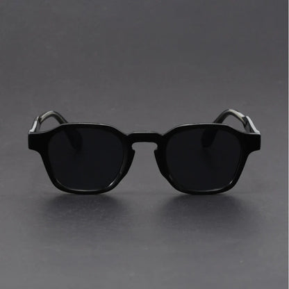 Black sunglasses on a gray background