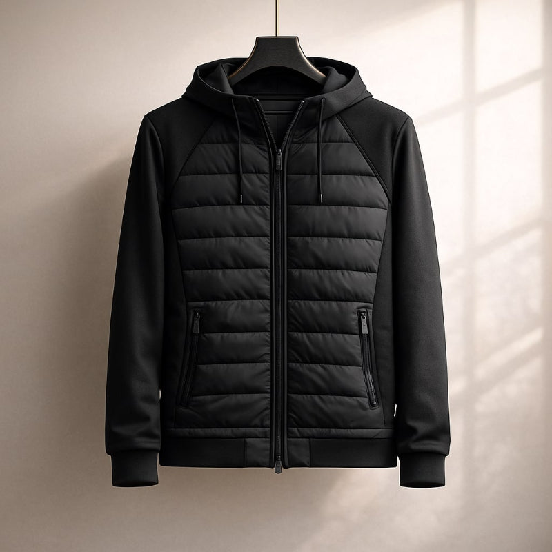 Black quilted jacket on a hanger against a neutral background