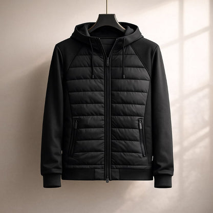 Black quilted jacket on a hanger against a neutral background