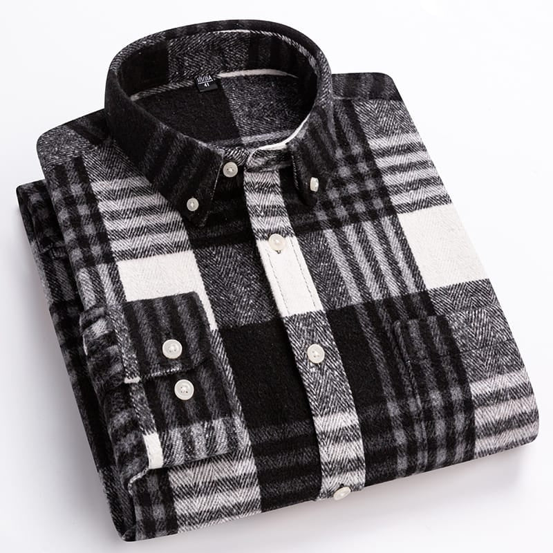 A folded long-sleeve plaid button-down shirt in black, white, and gray, displayed on a clean white background.