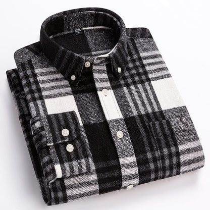 A folded long-sleeve plaid button-down shirt in black, white, and gray, displayed on a clean white background.