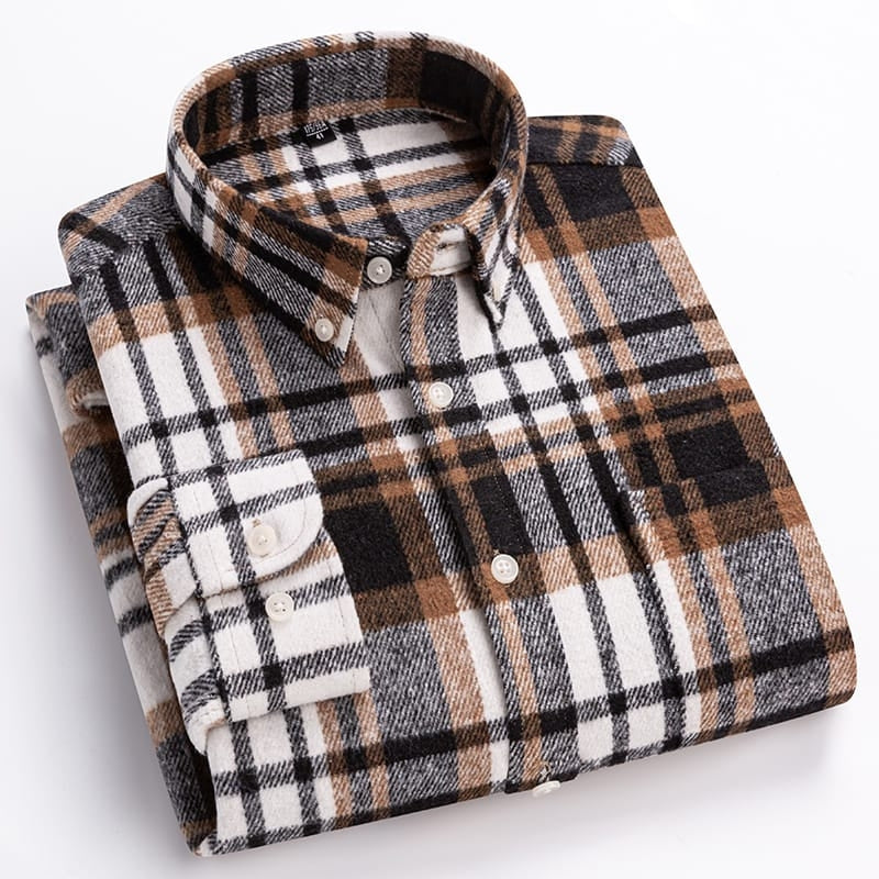 Folded plaid shirt with brown, black, and white pattern on a light gray background