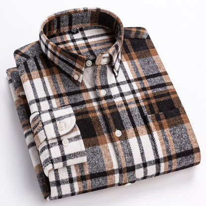 Folded plaid shirt with brown, black, and white pattern on a light gray background