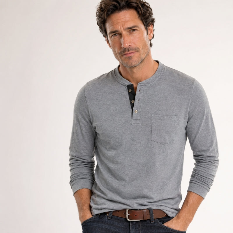 Man wearing a gray long-sleeve henley shirt on a white background