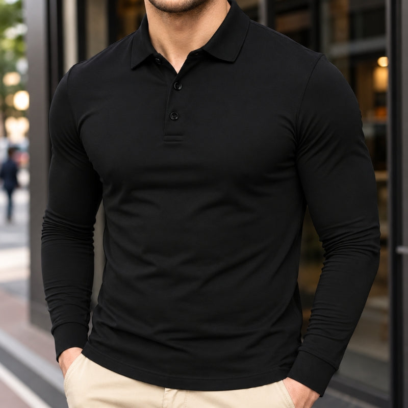 A man wearing a fitted black long-sleeve polo shirt with a three-button placket, paired with light beige pants, standing in front of a modern glass storefront.