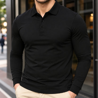 A man wearing a fitted black long-sleeve polo shirt with a three-button placket, paired with light beige pants, standing in front of a modern glass storefront.