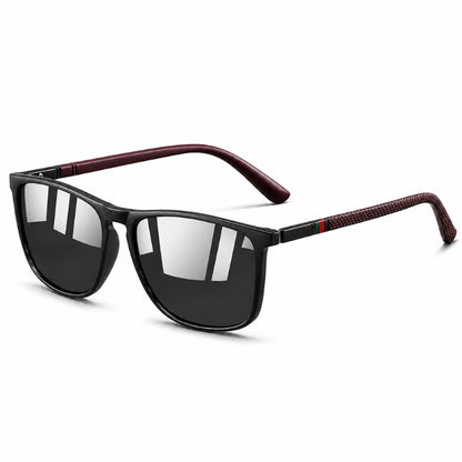 Sunglasses with black lenses and red and green accents on a white background