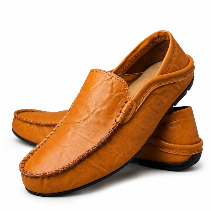 Pair of brown leather loafers on a white background
