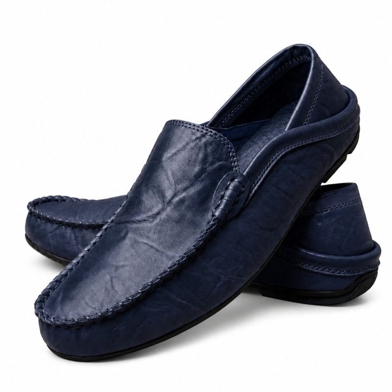 Pair of navy blue loafers on a white background