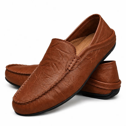 Brown leather loafers on a white background