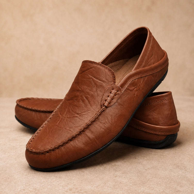 Brown leather loafers on a beige background