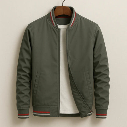 Green jacket with red and white trim on a beige background