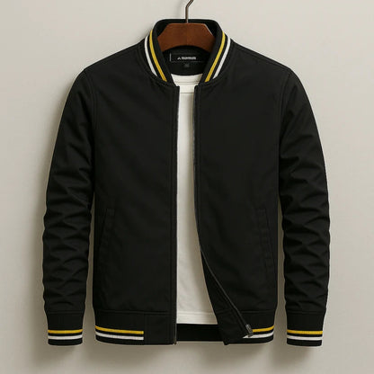 Black bomber jacket with yellow accents on a hanger against a neutral background