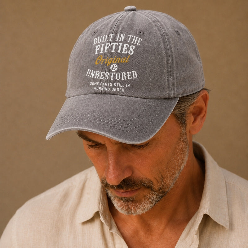 Man wearing a gray cap with text on a beige background