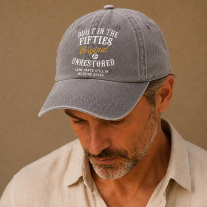 Man wearing a gray cap with text on a beige background