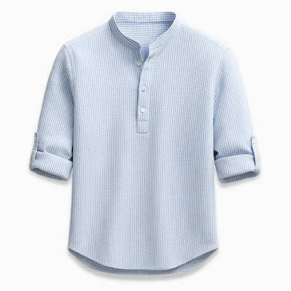Blue checkered shirt with rolled-up sleeves on a white background