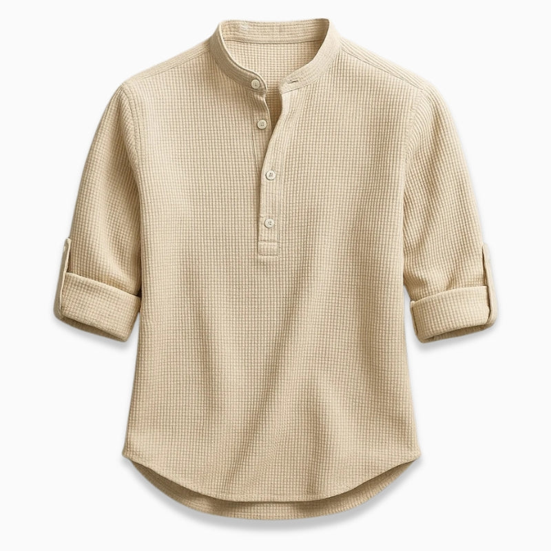 Beige checkered shirt with rolled-up sleeves on a white background