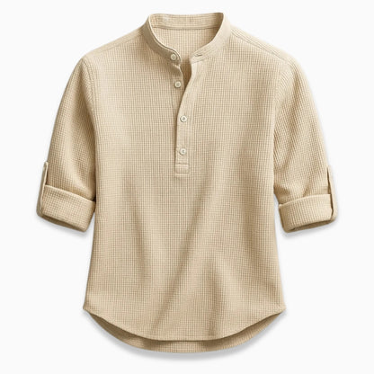 Beige checkered shirt with rolled-up sleeves on a white background