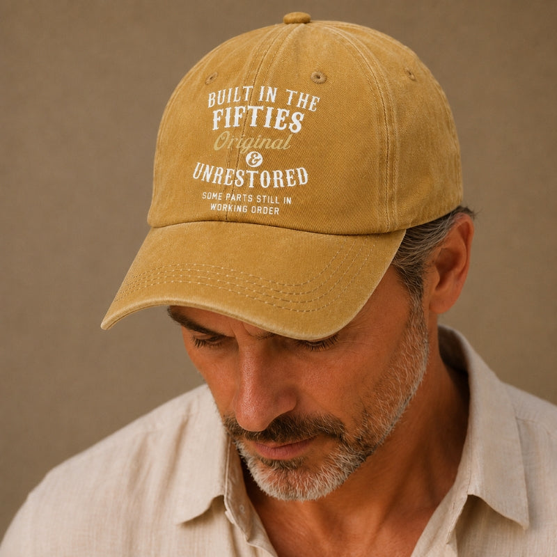Man wearing a tan cap with text on a beige background