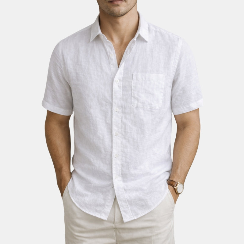 Man wearing a white linen shirt and beige pants on a white background