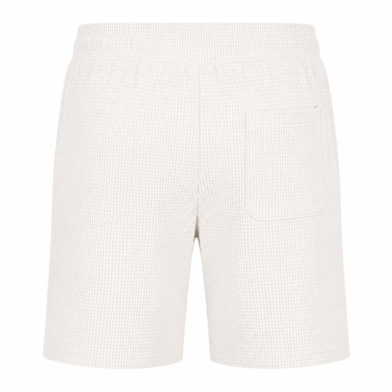 Off-white waffle-textured shorts with an elastic waistband and a single welt pocket on the left side, shown against a plain white background.