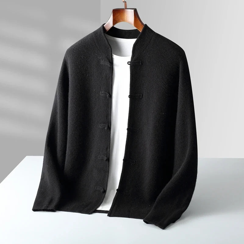 Black jacket on a hanger against a gray background