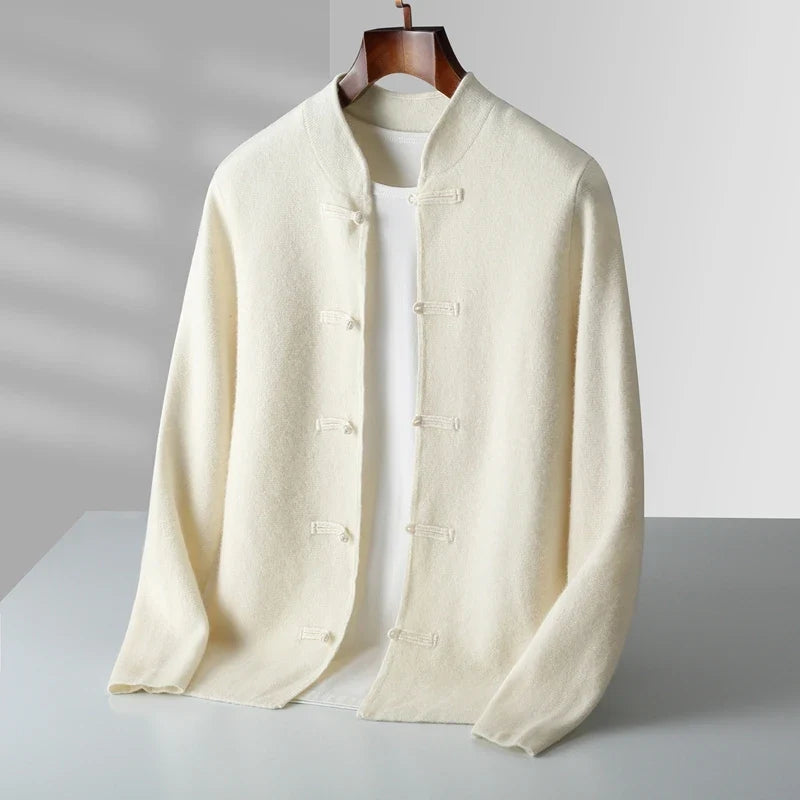 A cream-colored Chinese-style jacket with toggle closures, displayed on a hanger over a white t-shirt against a light gray background.