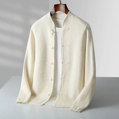 A cream-colored Chinese-style jacket with toggle closures, displayed on a hanger over a white t-shirt against a light gray background.