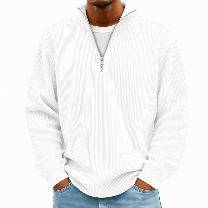 A man wearing a white ribbed long-sleeve quarter-zip pullover sweater over a white t-shirt and blue jeans, shown from the neck down against a plain white background.