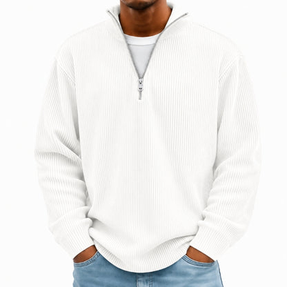 A man wearing a white ribbed long-sleeve quarter-zip pullover sweater over a white t-shirt and blue jeans, shown from the neck down against a plain white background.