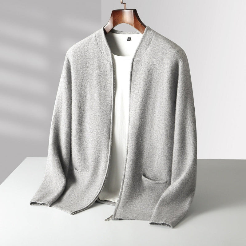 A light gray open-front knit cardigan with wide sleeves and patch pockets, displayed on a wooden hanger over a white top against a light gray background.