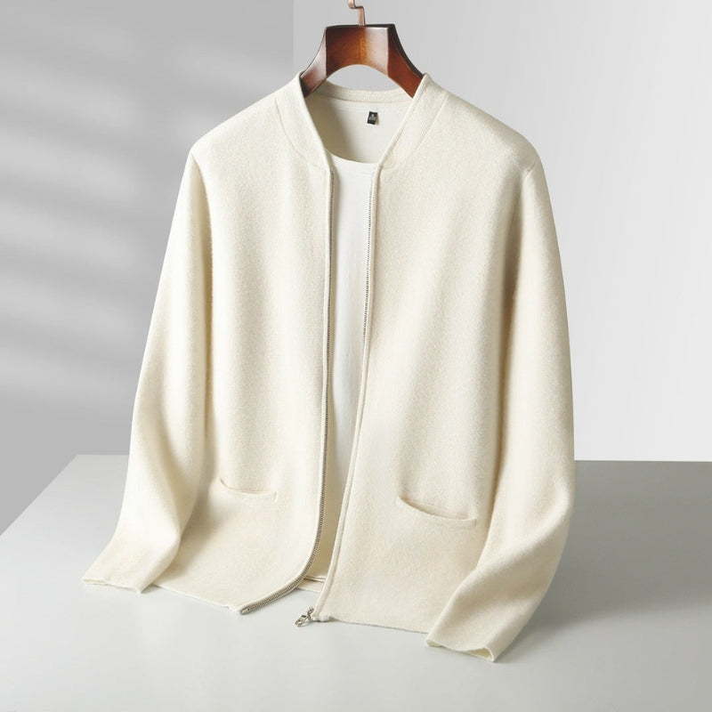An off-white knit zip-up cardigan sweater with a stand collar and front patch pockets, hanging on a wooden hanger against a light gray background.