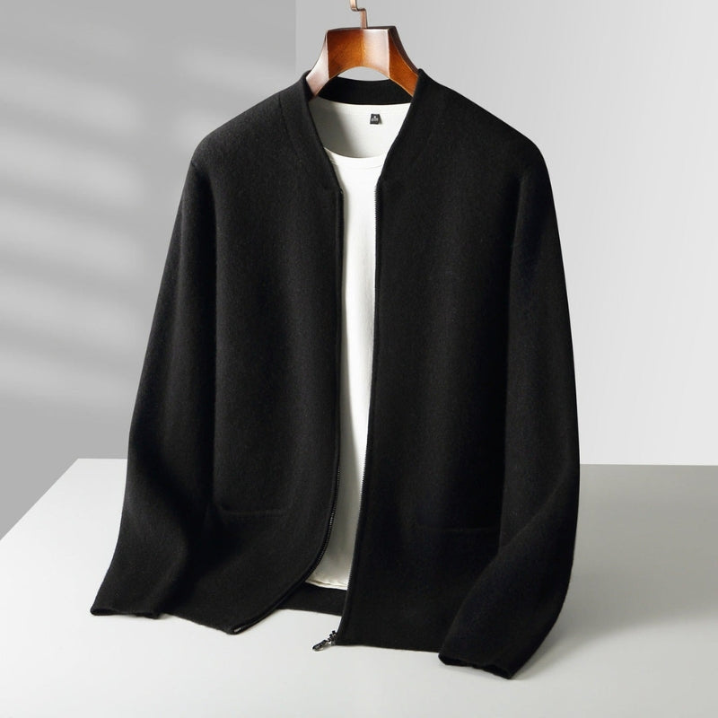 A black open-front knit cardigan or lightweight jacket displayed on a wooden hanger over a white top, set against a clean light gray studio background with soft shadowing.