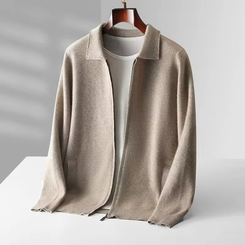 Beige sweater on a hanger against a gray background