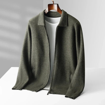 Green jacket on a hanger against a gray background